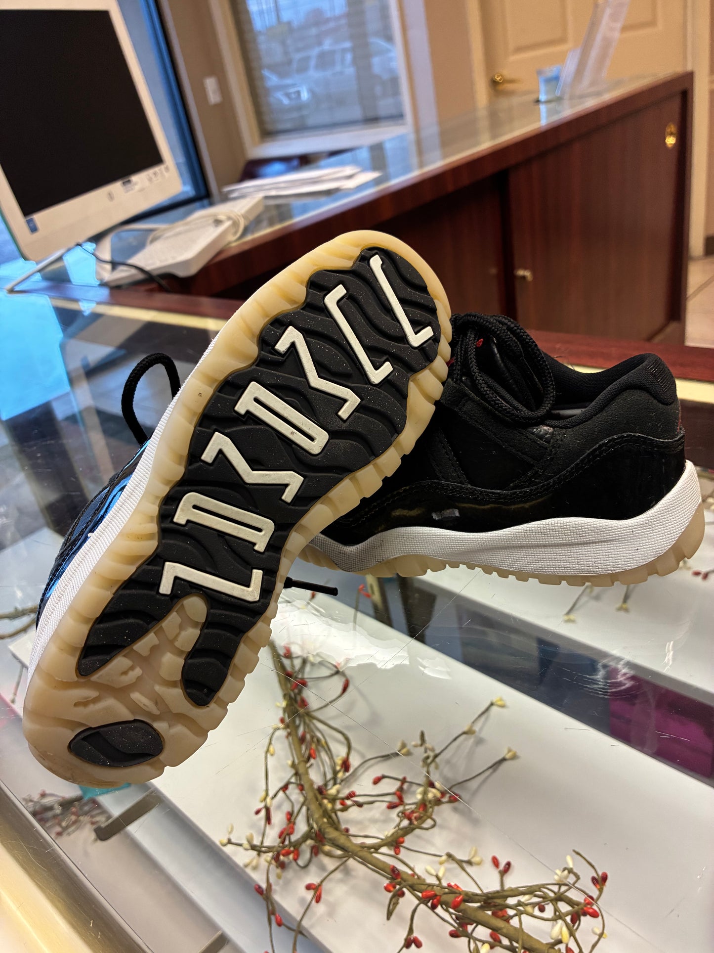Nike Air Jordan 11 Retro Low Boys size 1Y sneakers in black leather with a glossy finish