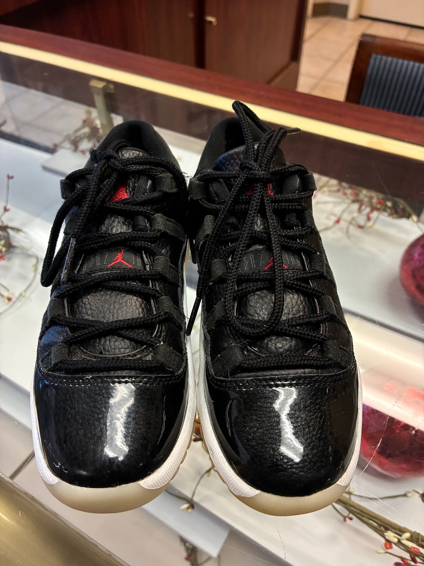 Nike Air Jordan 11 Retro Low Boys size 1Y sneakers in black leather with a glossy finish