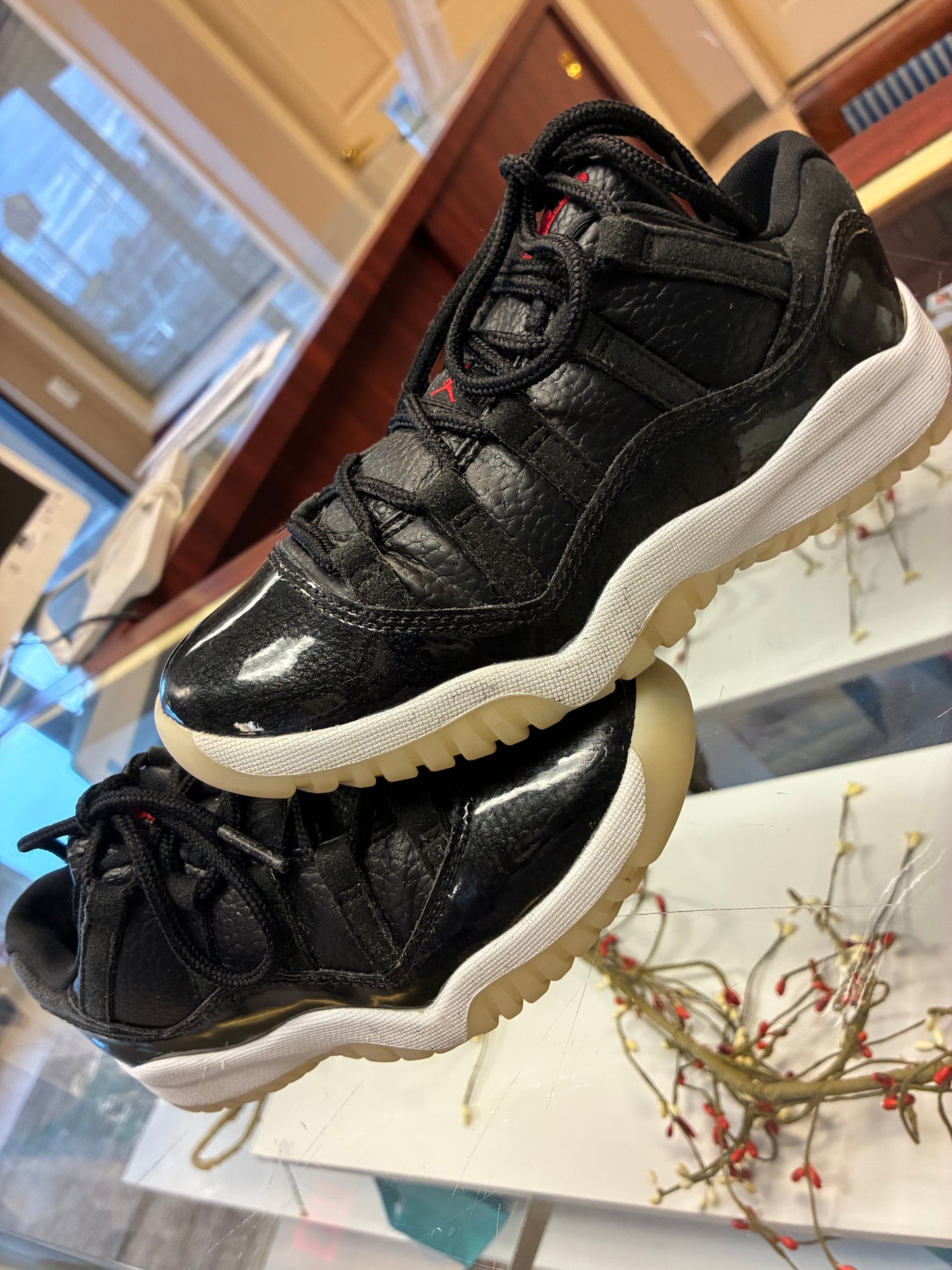Nike Air Jordan 11 Retro Low Boys size 1Y sneakers in black leather with a glossy finish