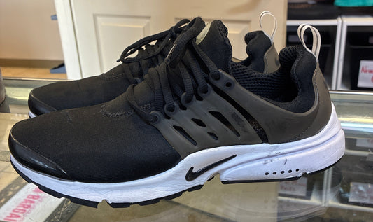 Nike Air Presto sneakers, in an all-black or "Triple Black" colorway Women US 10