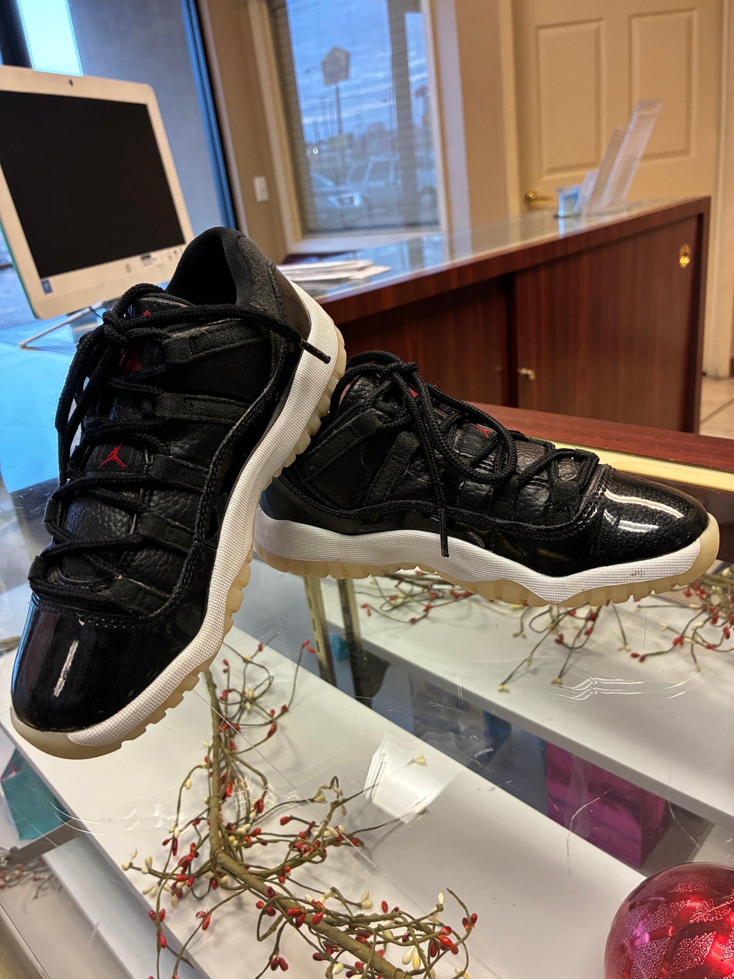 Nike Air Jordan 11 Retro Low Boys size 1Y sneakers in black leather with a glossy finish