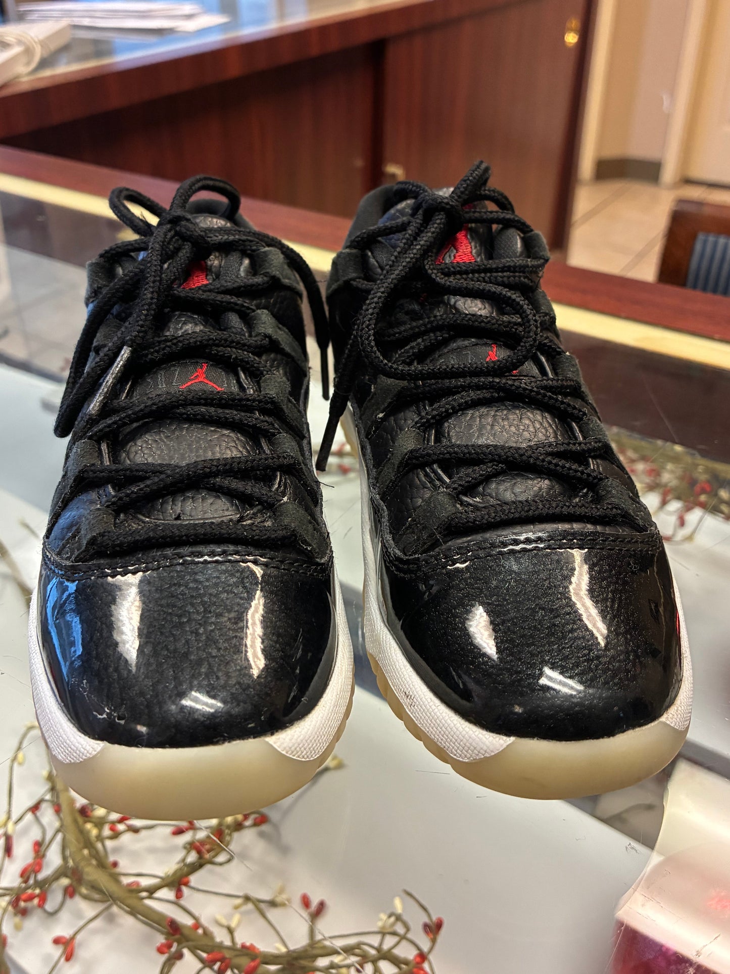 Nike Air Jordan 11 Retro Low Boys size 1Y sneakers in black leather with a glossy finish
